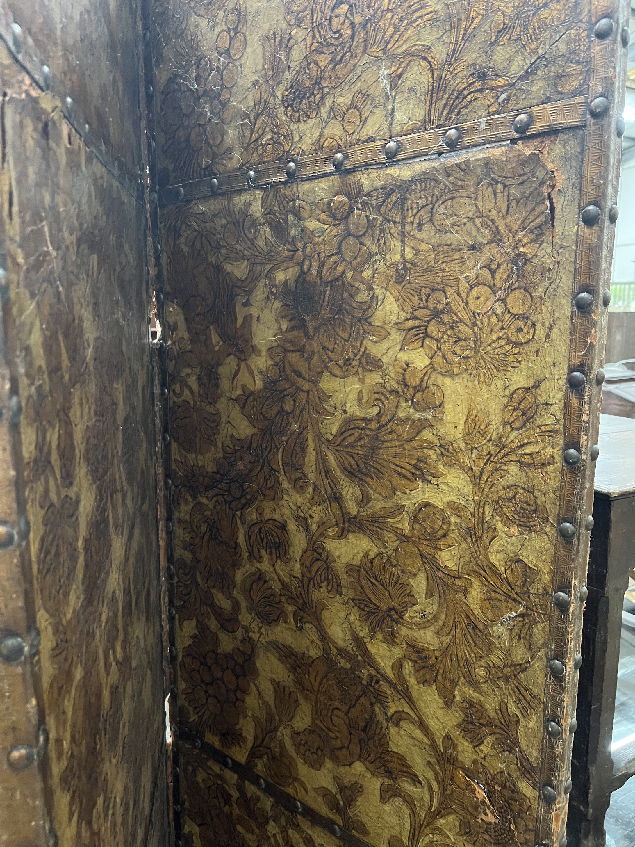 An 18th century Dutch leather four fold painted dressing screen, each panel width 61cm, height 198cm